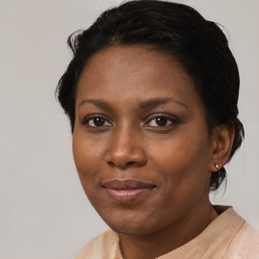 Joyful black adult female with short  brown hair and brown eyes