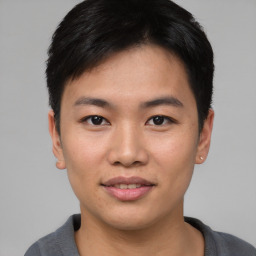 Joyful asian young-adult male with short  black hair and brown eyes