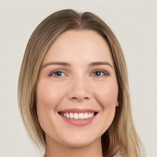 Joyful white young-adult female with long  brown hair and green eyes