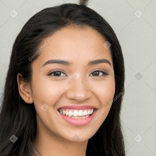 Joyful latino young-adult female with long  brown hair and brown eyes