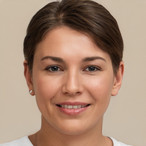 Joyful white young-adult female with short  brown hair and brown eyes