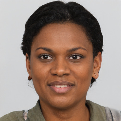 Joyful black young-adult female with short  black hair and brown eyes