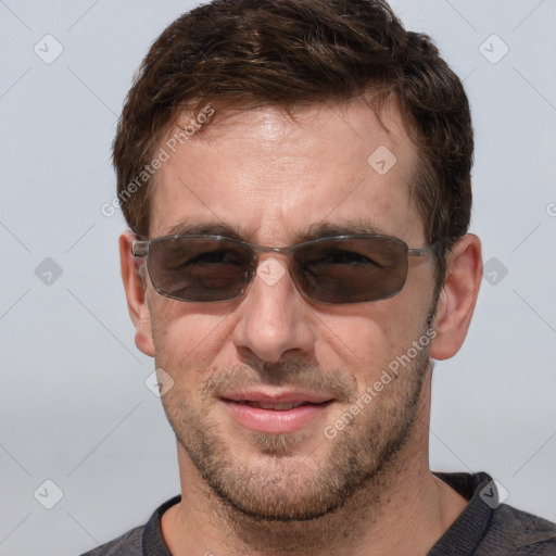 Joyful white adult male with short  brown hair and grey eyes