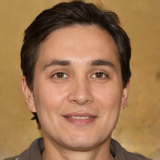 Joyful white adult male with short  brown hair and brown eyes