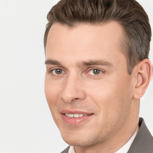 Joyful white adult male with short  brown hair and brown eyes