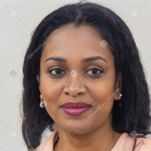 Joyful black young-adult female with long  brown hair and brown eyes