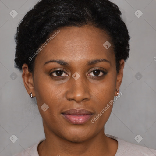 Joyful black young-adult female with short  black hair and brown eyes