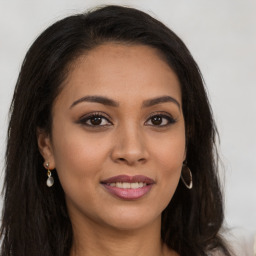 Joyful latino young-adult female with long  brown hair and brown eyes