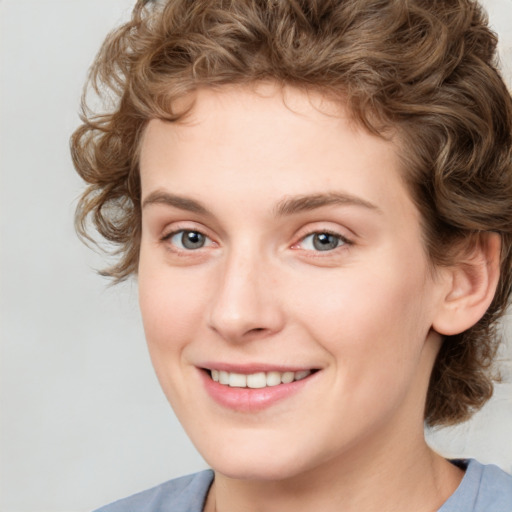 Joyful white young-adult female with medium  brown hair and blue eyes