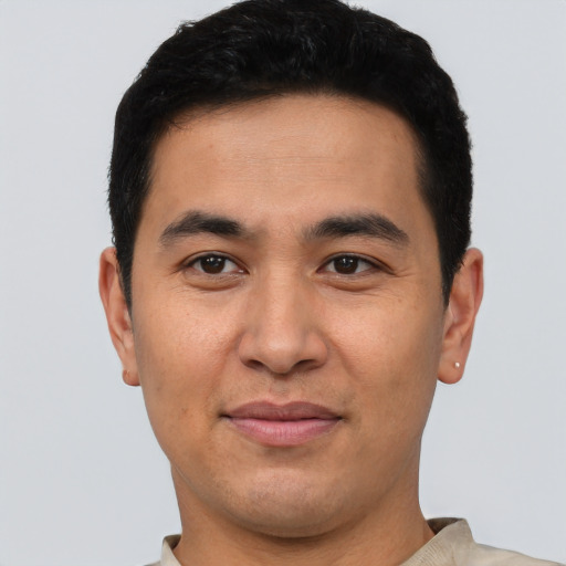 Joyful asian young-adult male with short  black hair and brown eyes