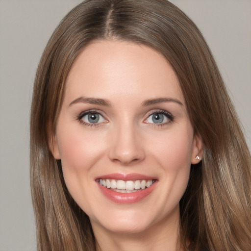 Joyful white young-adult female with long  brown hair and grey eyes