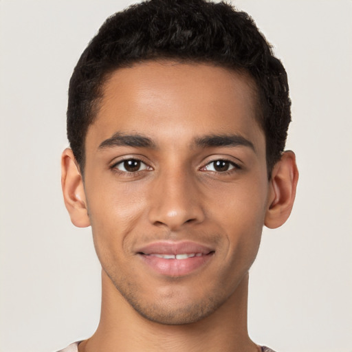 Joyful latino young-adult male with short  brown hair and brown eyes