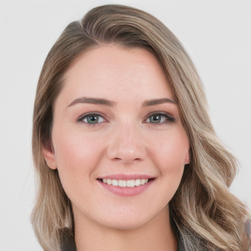 Joyful white young-adult female with long  brown hair and blue eyes