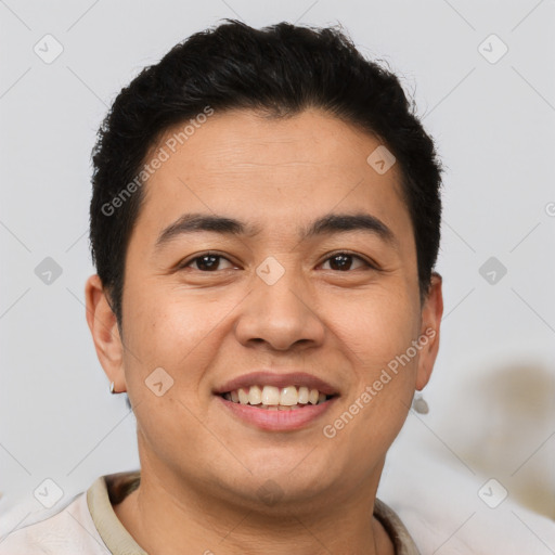 Joyful latino young-adult male with short  brown hair and brown eyes
