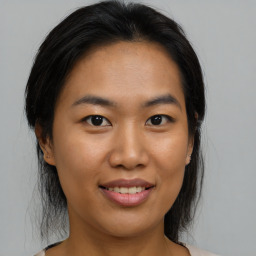 Joyful asian young-adult female with medium  brown hair and brown eyes