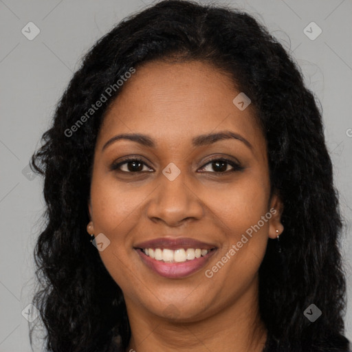 Joyful black young-adult female with long  brown hair and brown eyes