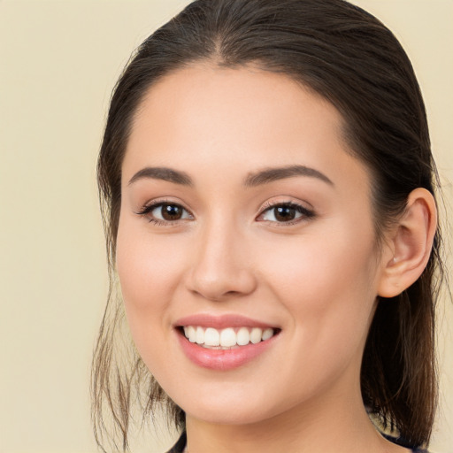 Joyful white young-adult female with long  brown hair and brown eyes