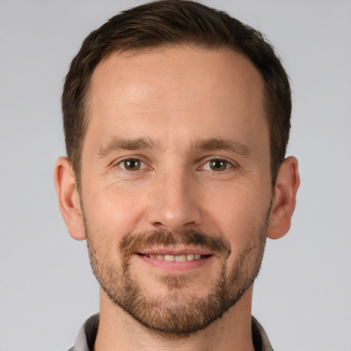 Joyful white young-adult male with short  brown hair and brown eyes