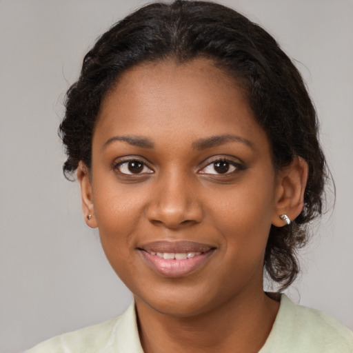 Joyful black young-adult female with medium  brown hair and brown eyes