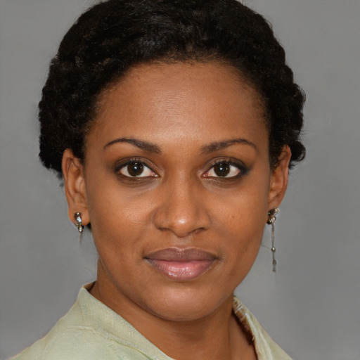 Joyful black young-adult female with short  brown hair and brown eyes