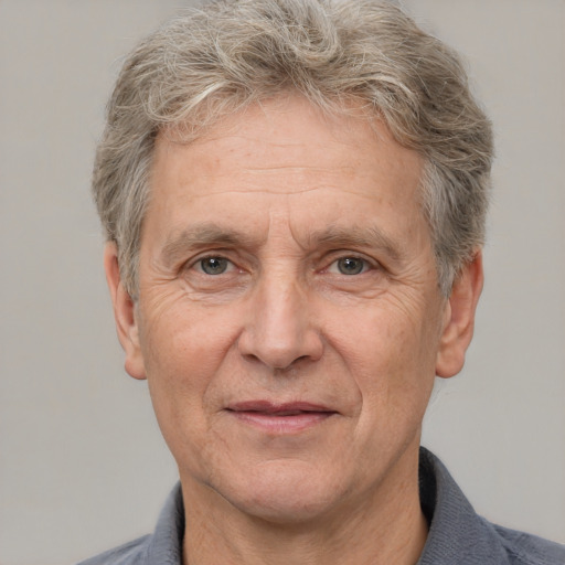 Joyful white middle-aged male with short  gray hair and brown eyes