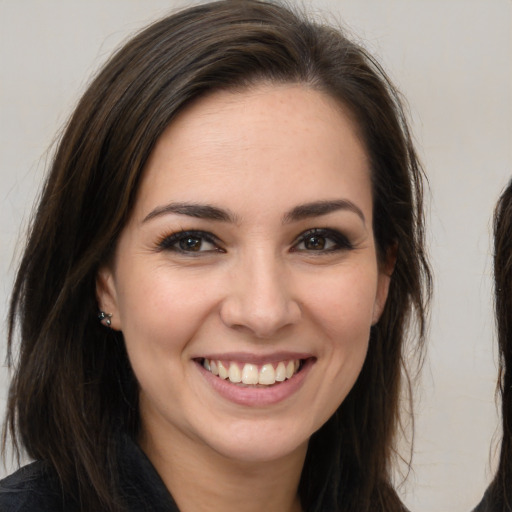 Joyful white young-adult female with long  brown hair and brown eyes