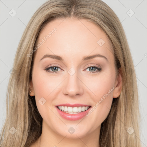 Joyful white young-adult female with long  brown hair and brown eyes