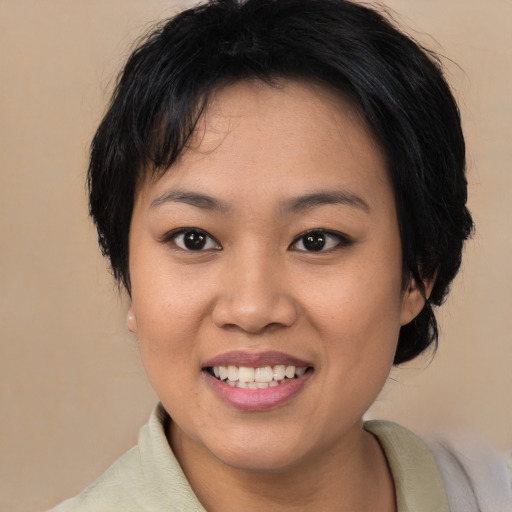 Joyful asian young-adult female with medium  black hair and brown eyes