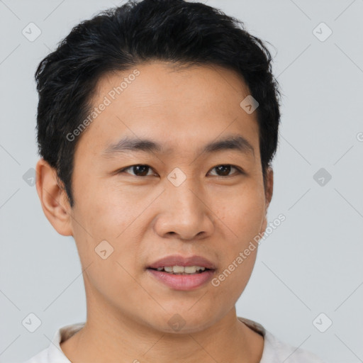 Joyful asian young-adult male with short  black hair and brown eyes