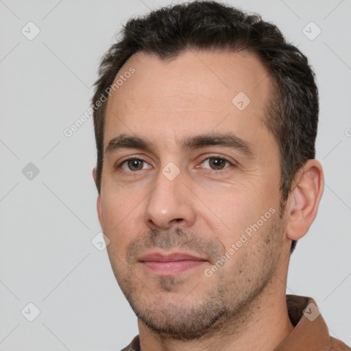 Joyful white young-adult male with short  black hair and brown eyes