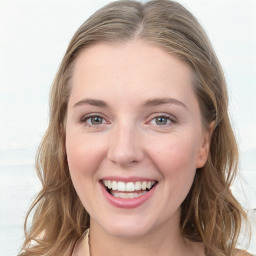 Joyful white young-adult female with long  brown hair and blue eyes