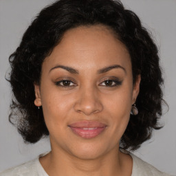 Joyful black adult female with medium  brown hair and brown eyes