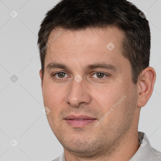 Joyful white young-adult male with short  brown hair and brown eyes