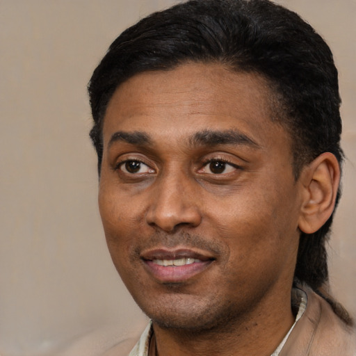 Joyful latino adult male with short  black hair and brown eyes