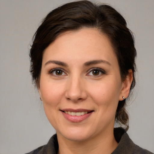 Joyful white young-adult female with medium  brown hair and brown eyes