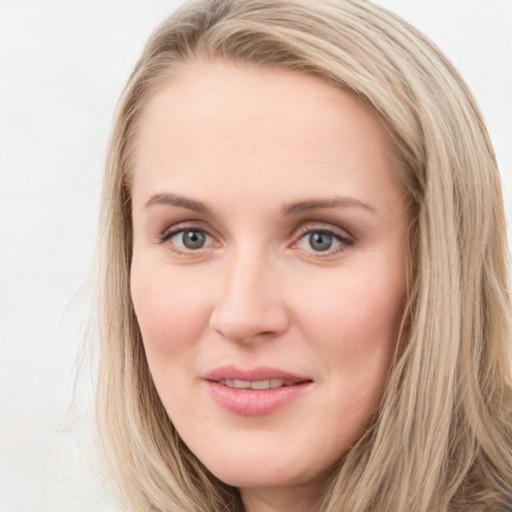 Joyful white young-adult female with long  brown hair and blue eyes