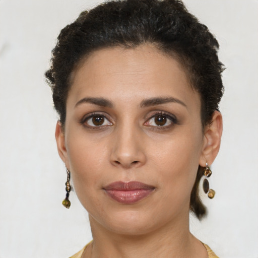 Joyful latino young-adult female with short  brown hair and brown eyes