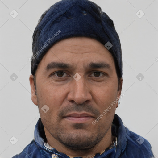 Joyful latino adult male with short  black hair and brown eyes