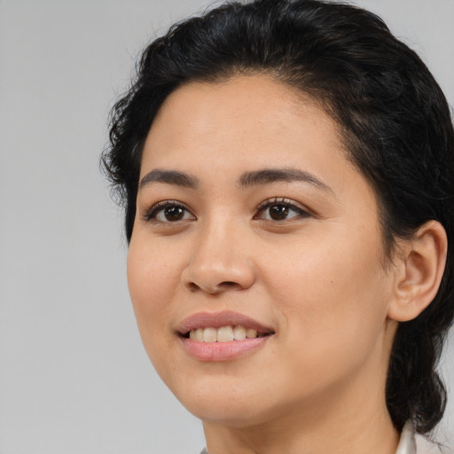 Joyful latino young-adult female with medium  black hair and brown eyes