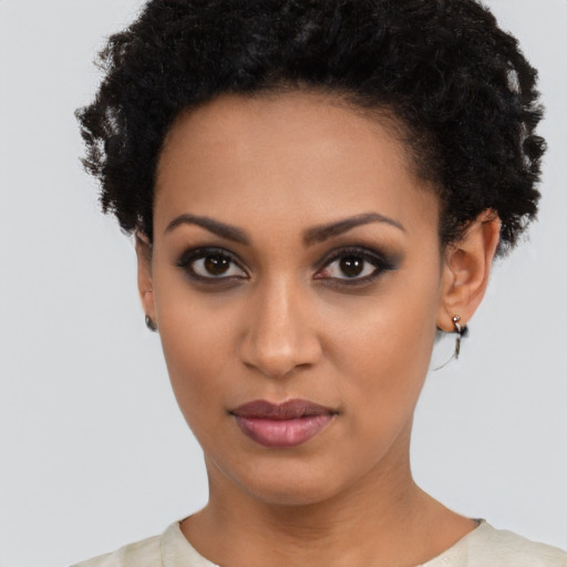 Joyful latino young-adult female with short  black hair and brown eyes