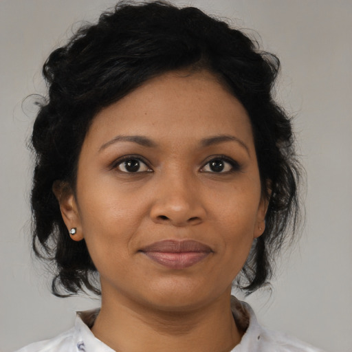 Joyful black young-adult female with medium  black hair and brown eyes