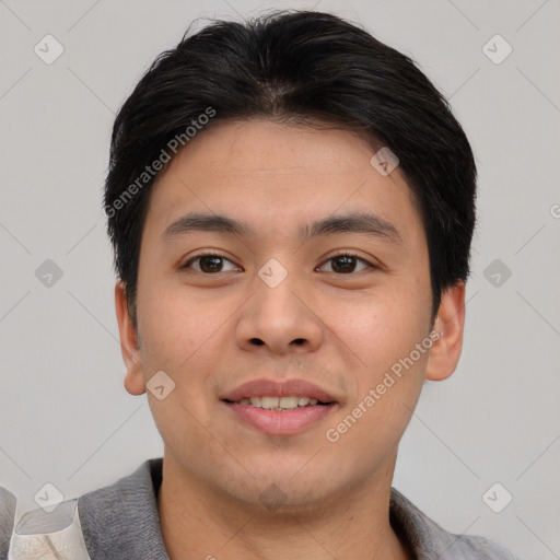 Joyful asian young-adult male with short  brown hair and brown eyes