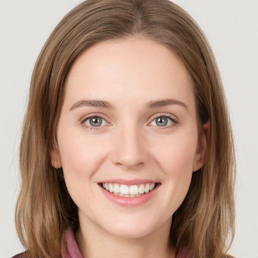 Joyful white young-adult female with long  brown hair and grey eyes