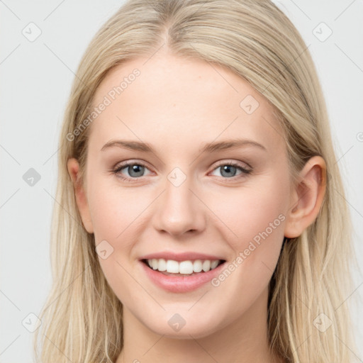 Joyful white young-adult female with long  brown hair and blue eyes