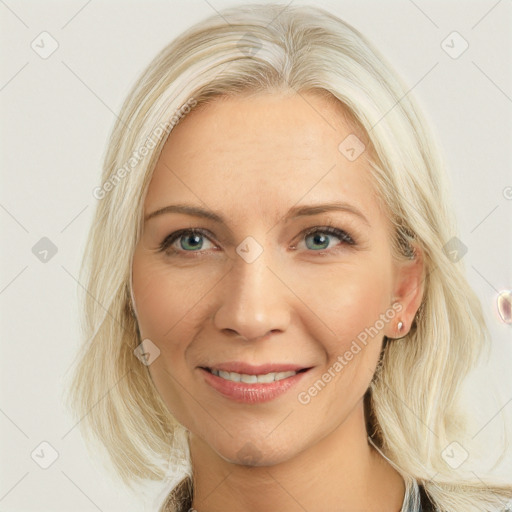 Joyful white young-adult female with long  blond hair and blue eyes