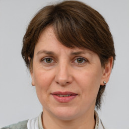 Joyful white adult female with medium  brown hair and grey eyes