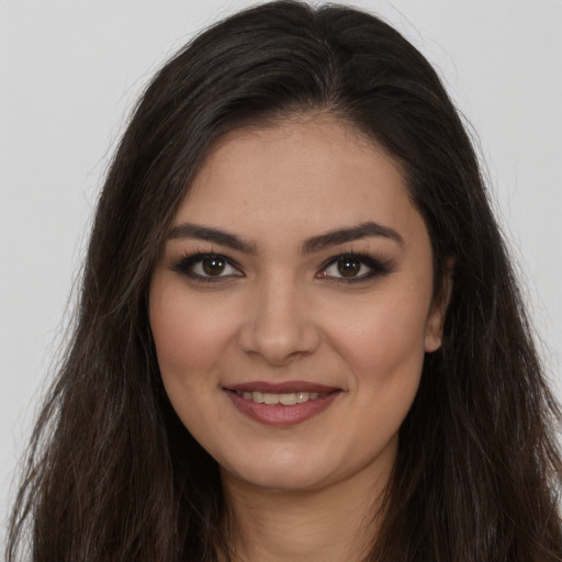Joyful white young-adult female with long  brown hair and brown eyes