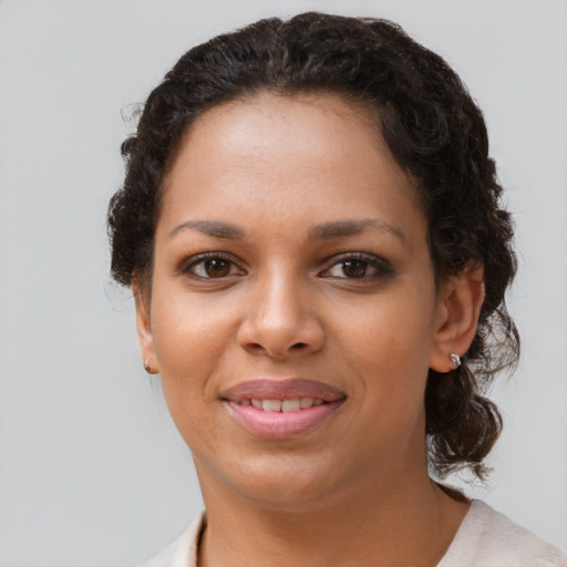 Joyful black young-adult female with short  brown hair and brown eyes