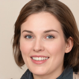 Joyful white young-adult female with medium  brown hair and blue eyes