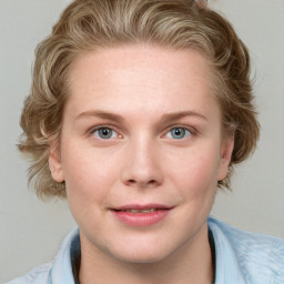 Joyful white young-adult female with medium  brown hair and blue eyes